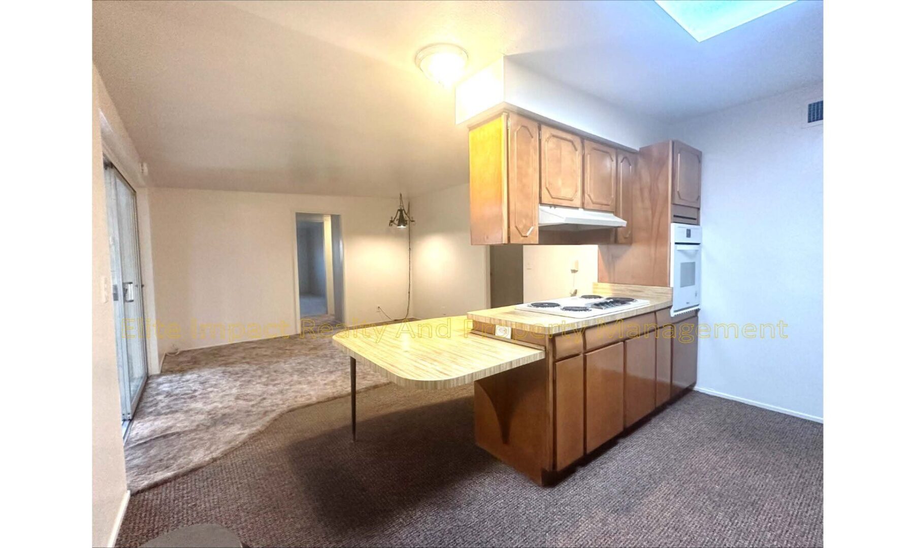 Kitchen island with granite countertop and wooden cabinets in cozy home.