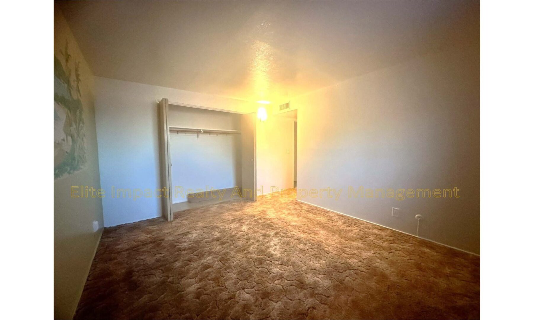 Empty room with carpet and a built-in shelf.