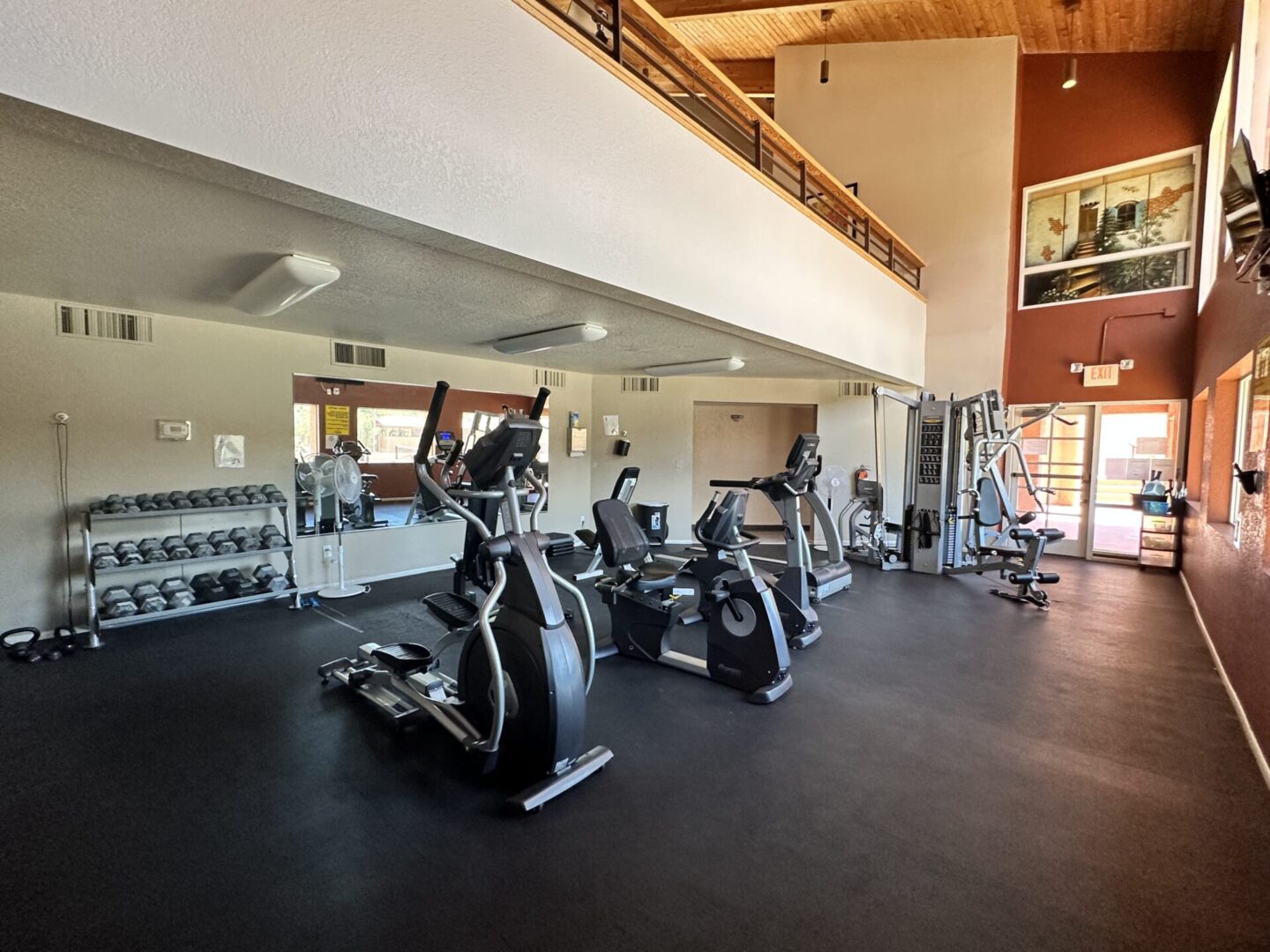 Modern gym with exercise bikes and ample lighting.