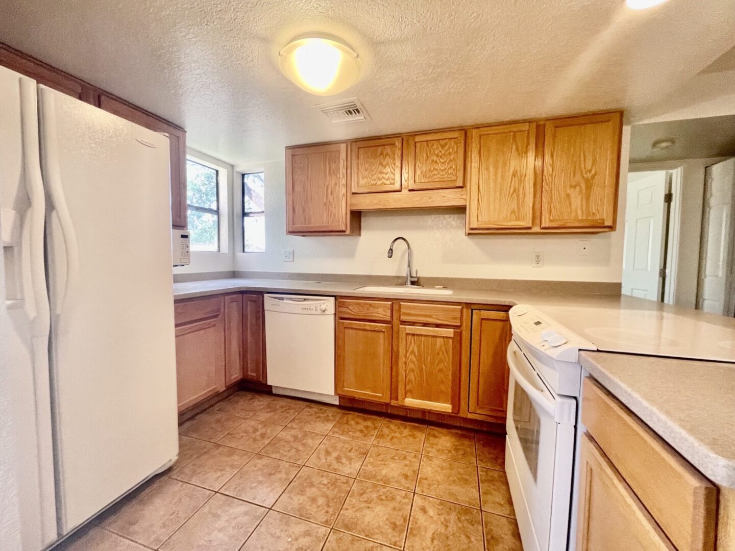 Bright kitchen with wooden cabinets and modern appliances.