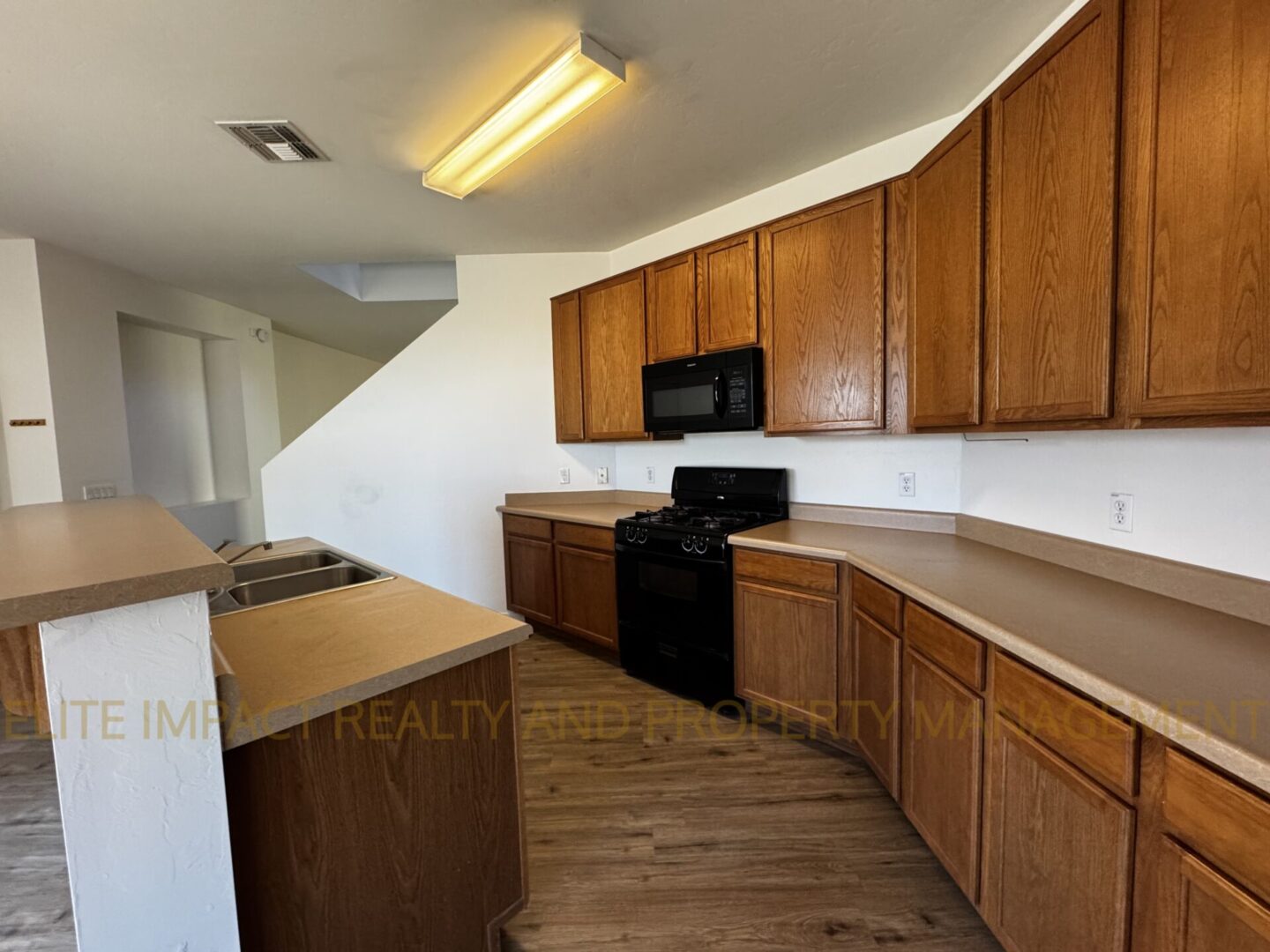 Spacious kitchen with wooden cabinets and modern appliances.