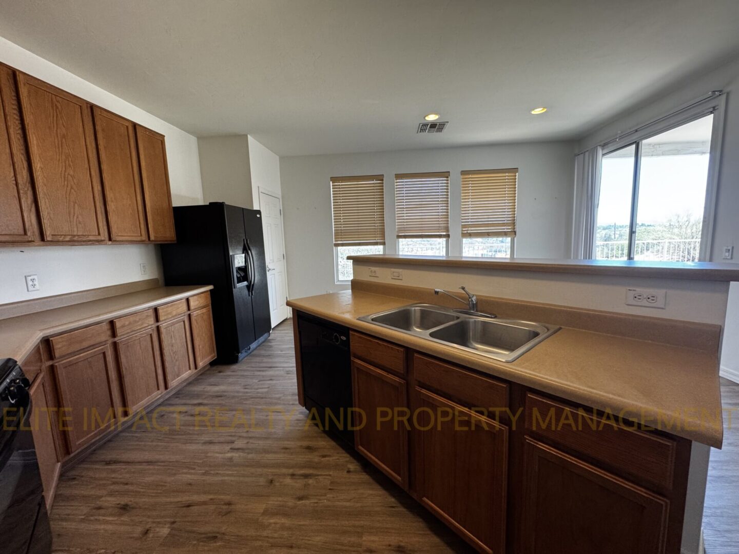Spacious kitchen with wooden cabinets and breakfast bar.